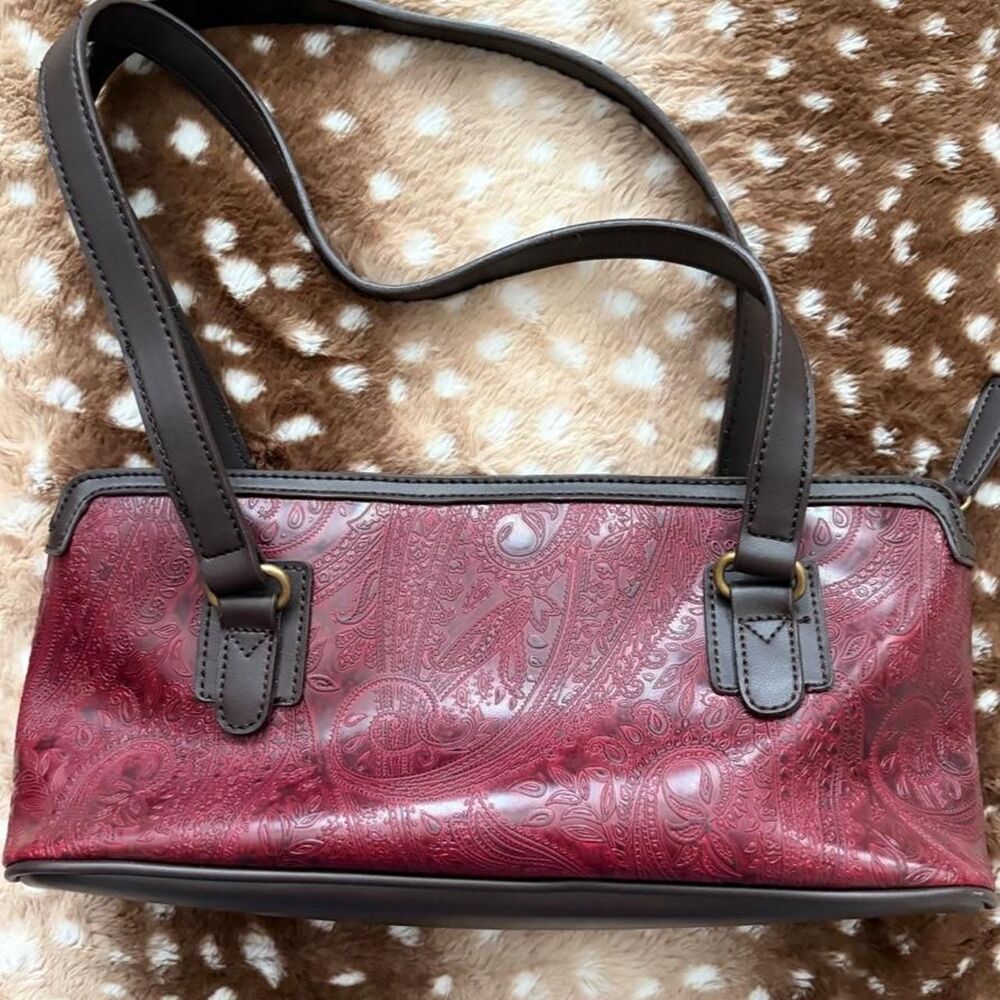 Burgundy leather handbag with embossed paisley design